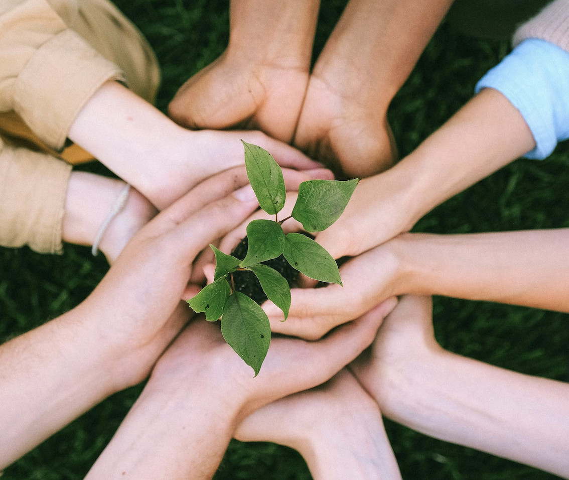 community volunteers putting their hands together to